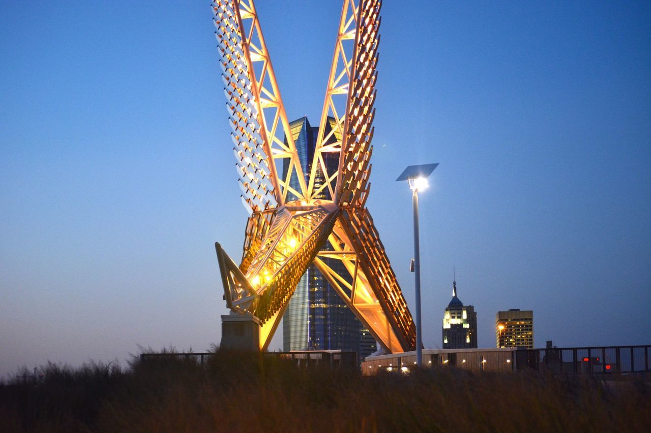 clear sky, built structure, architecture, low angle view, copy space, building exterior, blue, tall - high, tower, crane - construction machinery, dusk, illuminated, development, construction site, outdoors, amusement park ride, amusement park, night, sky, arts culture and entertainment