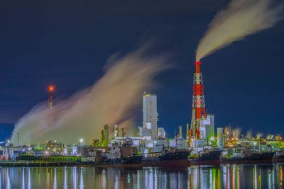 Cooling tower and chimney at night