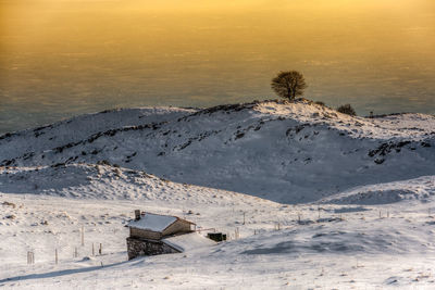 Scenic view of landscape against sky during winter