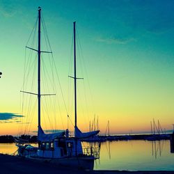 Sailboats in marina at sunset