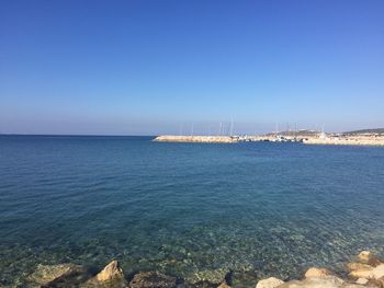 Scenic view of sea against clear blue sky