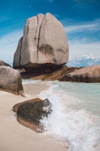 Rock formation in sea against sky