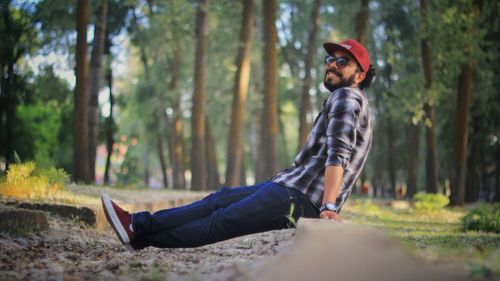 Side view of young man in forest