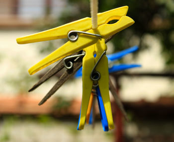 Close-up of clothespins hanging on clothesline