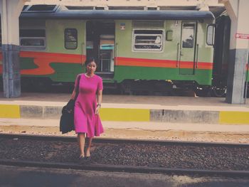 Full length of woman standing by railing