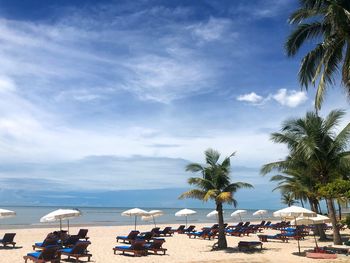 Panoramic view of people on beach against sky