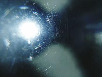 Full frame shot of wet spider web in glass window