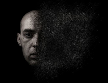 Digital composite image of man against black background