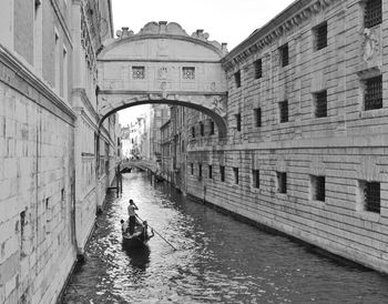 People walking on bridge over canal