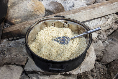 High angle view of bread in container on rock