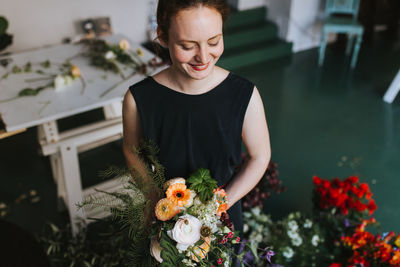 Woman holding flowers at home