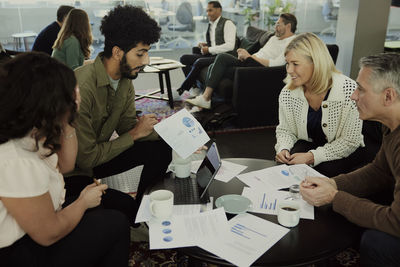 Group of business people having meeting in lobby