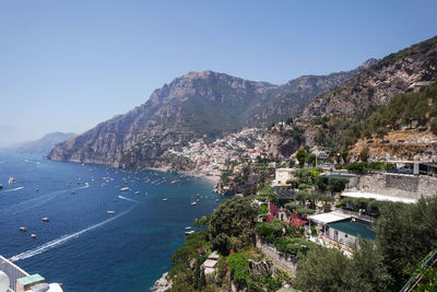 High angle view of sea and mountains against clear sky