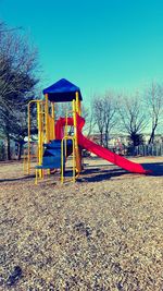 Rear view of woman standing against clear blue sky