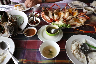 Cropped image of person having food at restaurant