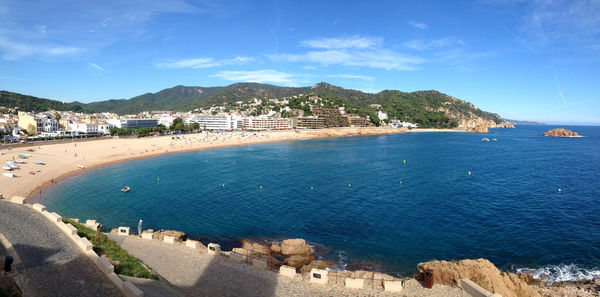 Panoramic view of city by sea against sky