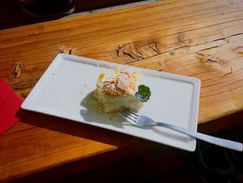 High angle view of cake served on wooden table