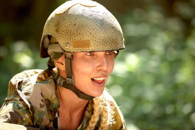 Portrait of young woman wearing hat standing outdoors