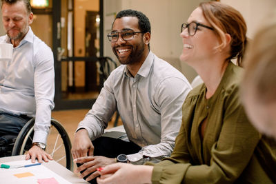 Business professionals smiling during sales meeting in office