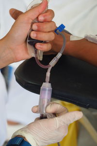 Cropped image of doctor and patient at blood bank