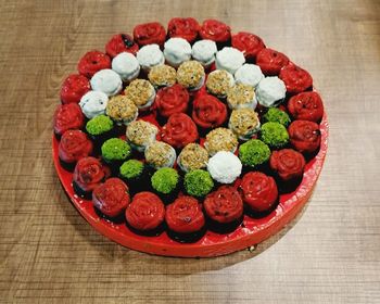 High angle view of multi colored candies in plate on table