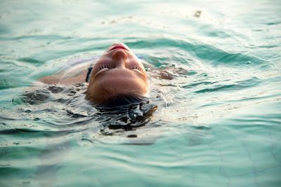 Portrait of young man swimming in pool