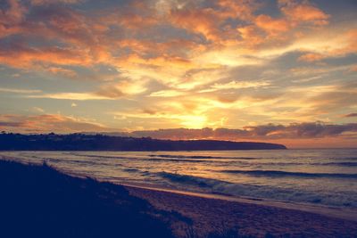 Scenic view of beach against sky during sunset