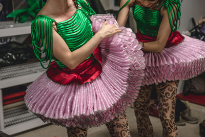 Midsection of dancers in costumes