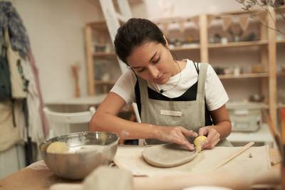 Woman working on clay