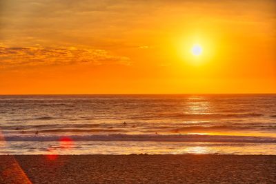 Scenic view of sea against orange sky