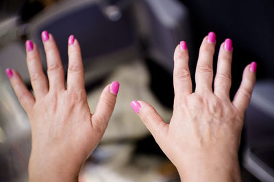 Close-up of woman hand with pink nail polish