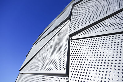 Low angle view of modern building against clear blue sky