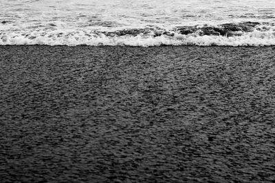 High angle view of waves rushing towards shore