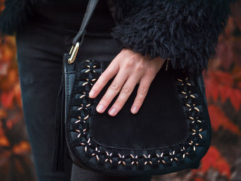 Close-up midsection of woman holding bag
