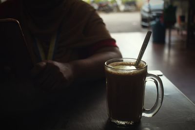 Close-up of man holding coffee cup