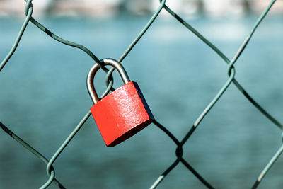 Close-up of padlocks on chainlink fence