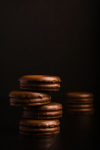 Close-up of stack on table against black background