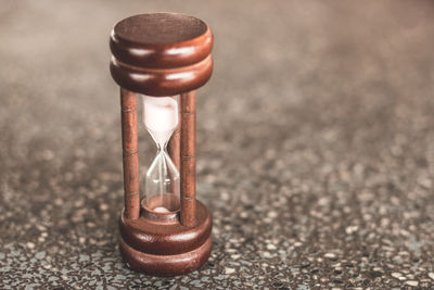 Close-up of hourglass on wet street