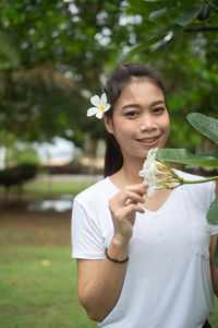 Portrait of a smiling young woman holding ice cream