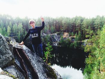 Woman standing on rocks in forest