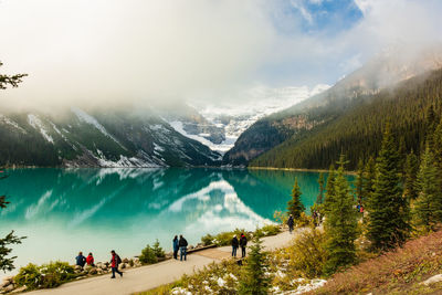 Scenic view of lake and mountains against cloudy sky