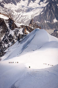 Group of people on snowcapped mountain