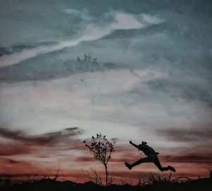 Side view of silhouette man jumping against sky during sunset