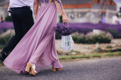 Low section of woman standing on street