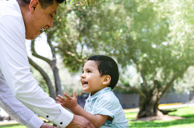 Side view of father and baby boy