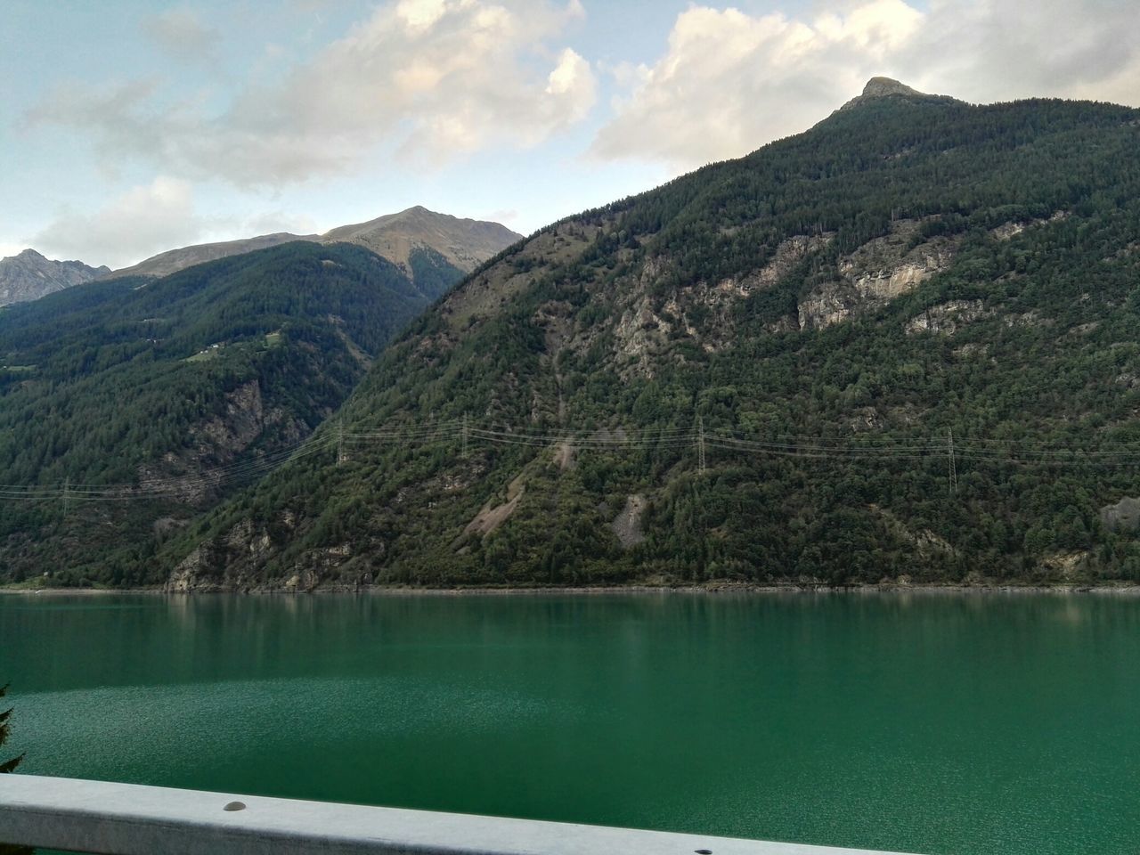 mountain, water, tranquil scene, tranquility, scenics, mountain range, lake, beauty in nature, sky, nature, reflection, tree, idyllic, non-urban scene, river, cloud, waterfront, cloud - sky, landscape, day