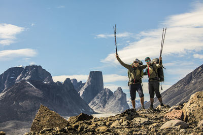 Portrait of two backpackers on mountain ridge in akshayak pass,