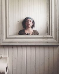 Portrait of young woman on wooden floor