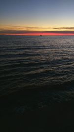 Scenic view of sea against clear sky at sunset