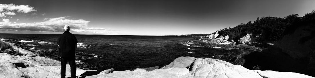Panoramic view of frozen lake against sky